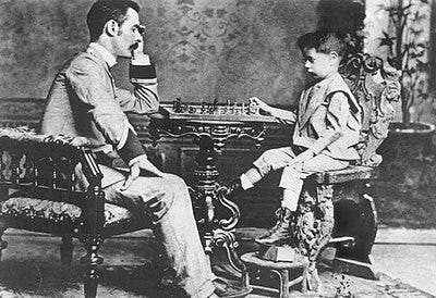 A four-year-old Capablanca playing chess with his father in 1892