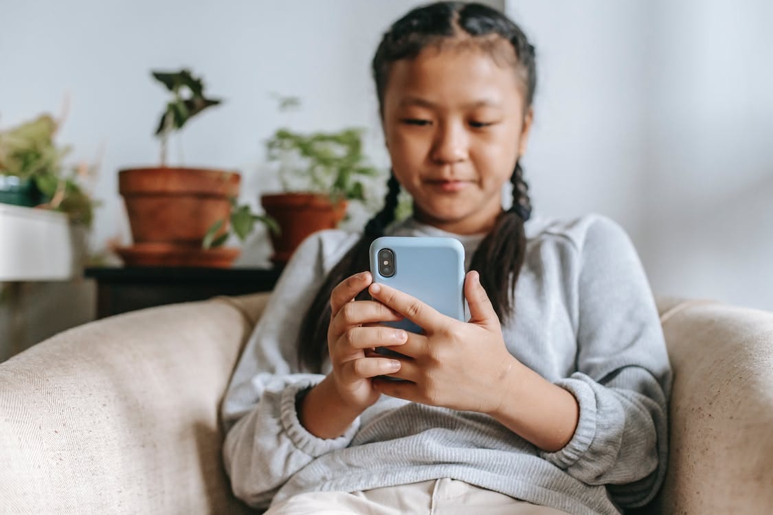 Free Serious ethnic girl with smartphone Stock Photo