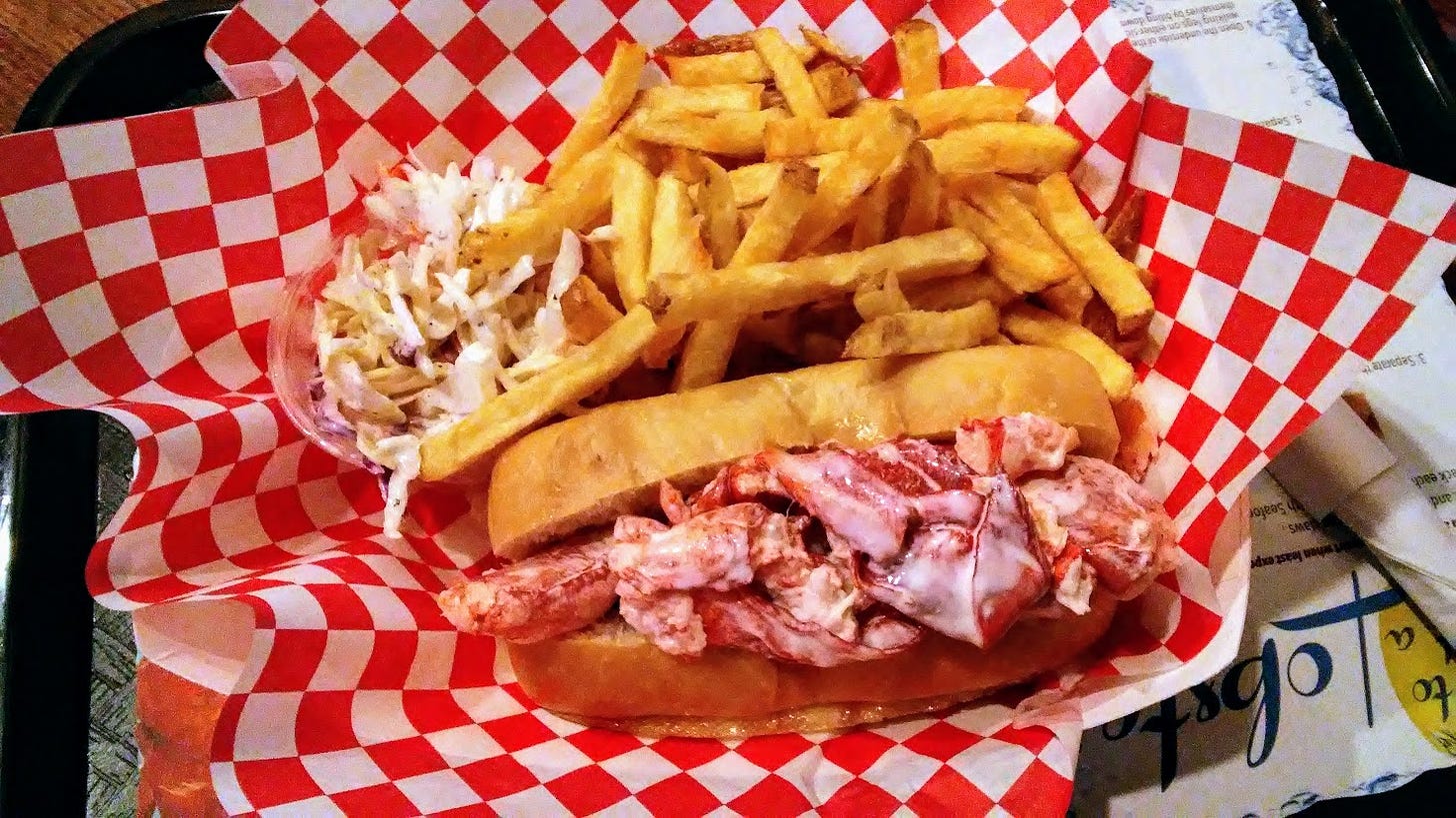 Lobster roll and fries in basket