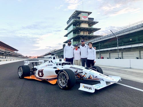 Autonomous Tiger Racing team members (from left to right) Brendan Schretter, Elizabeth Keefer, Will Bryan and Stephanie Meyer pose with their autonomous vehicle at the Indianapolis Motor Speedway. The team will compete in the first-ever Indy Autonomous Challenge on Oct. 23, 2021.