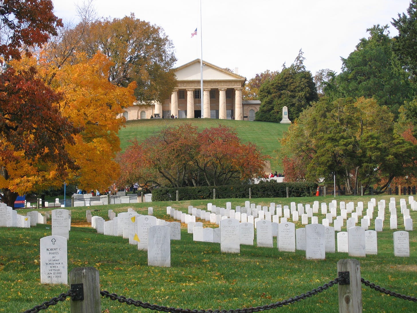 Photo shows Arlington House in the background.  White tombstones can be seen in rows in the foreground.