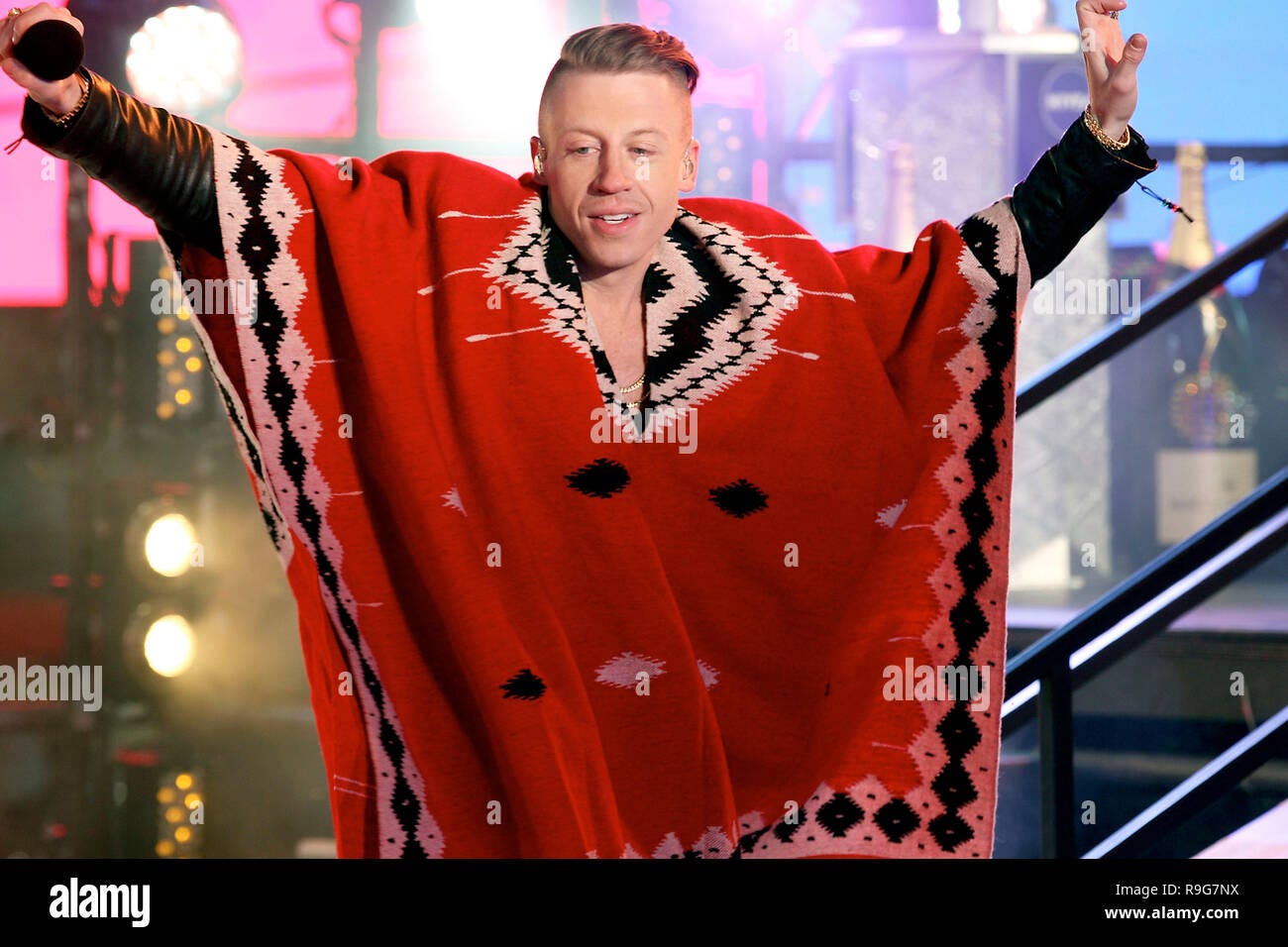 NEW YORK, NY - DECEMBER 31: Macklemore performs on stage at the New Year's  Eve 2014 ball drop celebration in Times Square on December 31, 2013 in New  York City. (Photo by