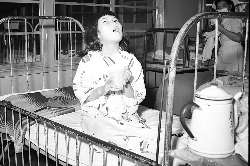 A girl drinks broth in a Japanese hospital during the 1957 Asian flu outbreak, which first emerged in China and later spread throughout Asia. Like with COVID, Chinese officials were accused of covering up its earliest cases.“