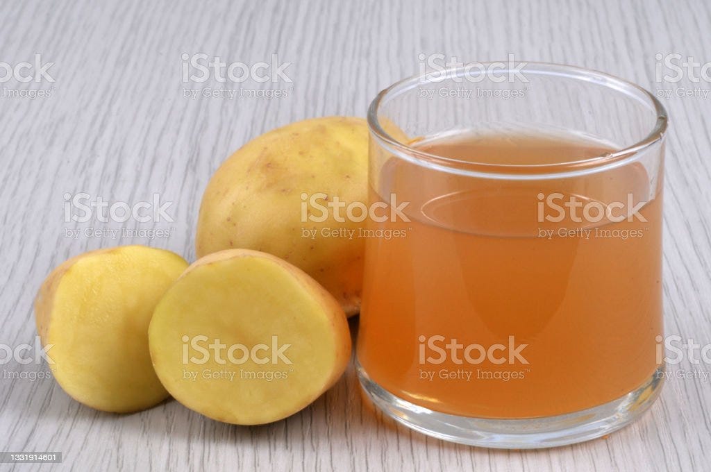 Vegetable juice Glass of potato juice with its ingredients in close-up on a gray background Juice - Drink Stock Photo