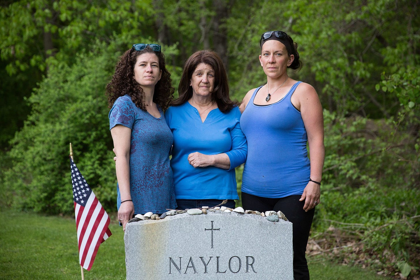 Erin Naylor, Kate Naylor, and Meghan Naylor pose for a portrait during a visit to Pete Naylor's grave in May 2018.