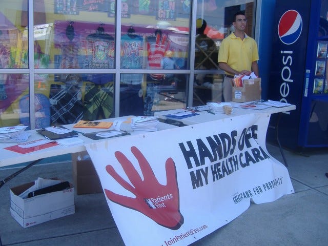 Nick Loffer of Americans for Prosperity looks over a table full of items encouraging support for true health care reform.