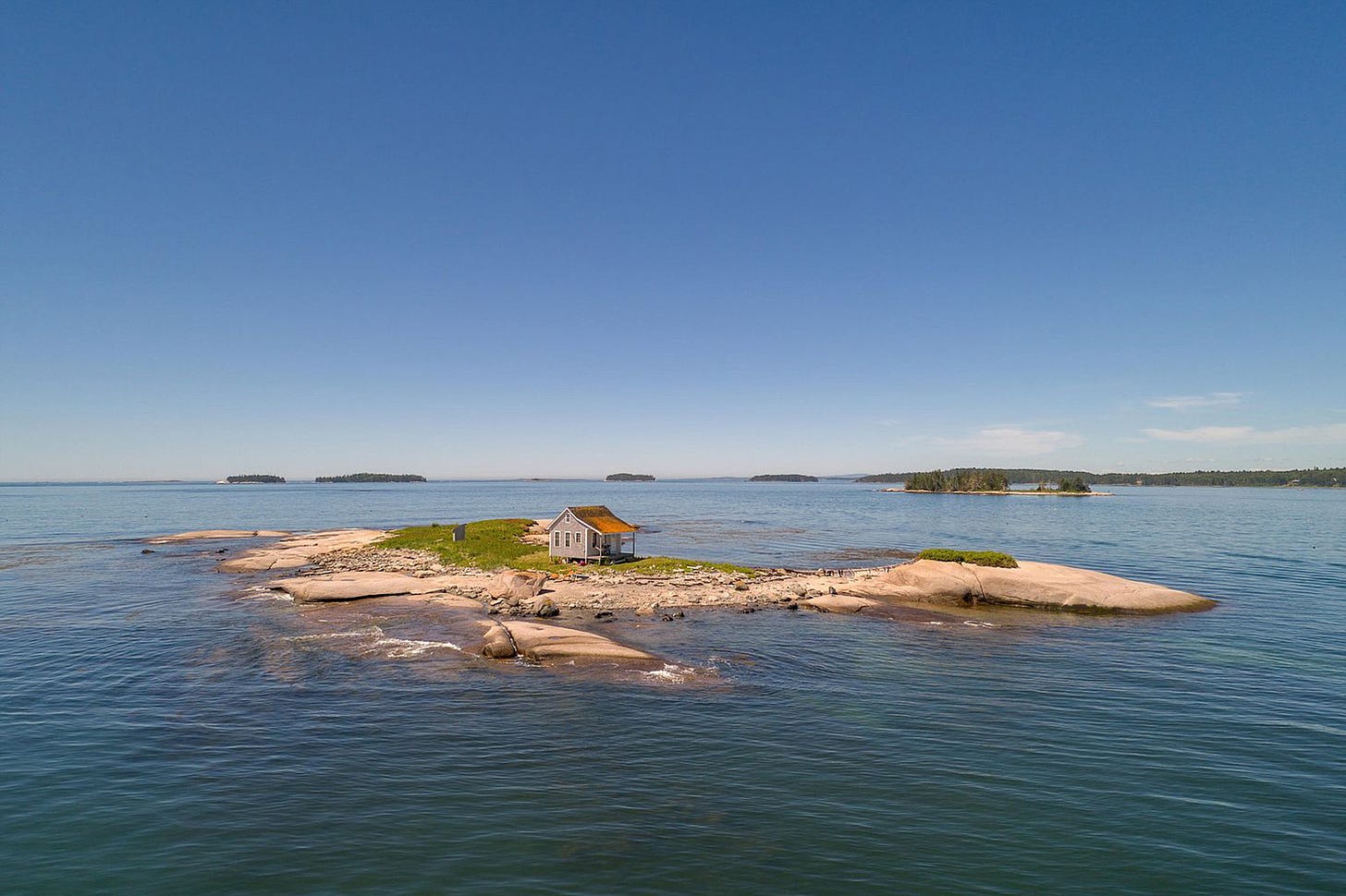 A picture from Zillow of all of Duck Ledges Island and the little house on it. 