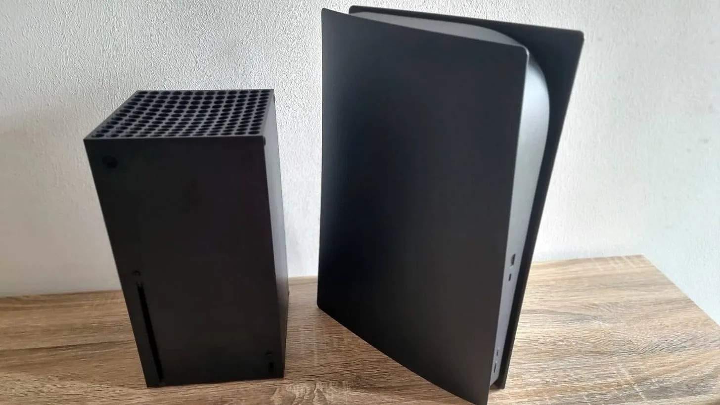 Xbox Series X and PS5 with black faceplates stood side by side
