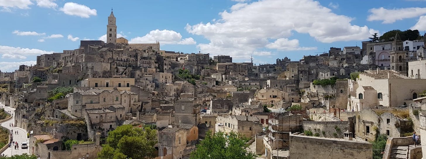 A photo of Sass di Matera, showing the stone buildings rising up the hillside. 