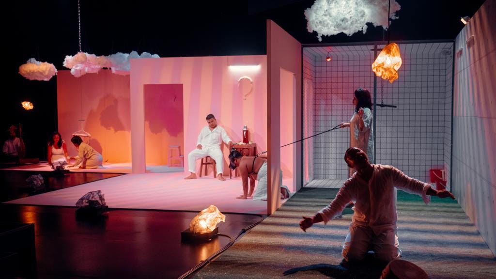 A view of the set of ANAK featuring performers (from left) Shafiqhah Efandi, Rusydina Afiqah, Ali Mazrin, Al Hafiz Sanusi, Farah Lola and Saifuddin Jumadi. The walls of the set are painted pink and white clouds are suspended overhead. (Photo credit: Akbar Syadiq)
