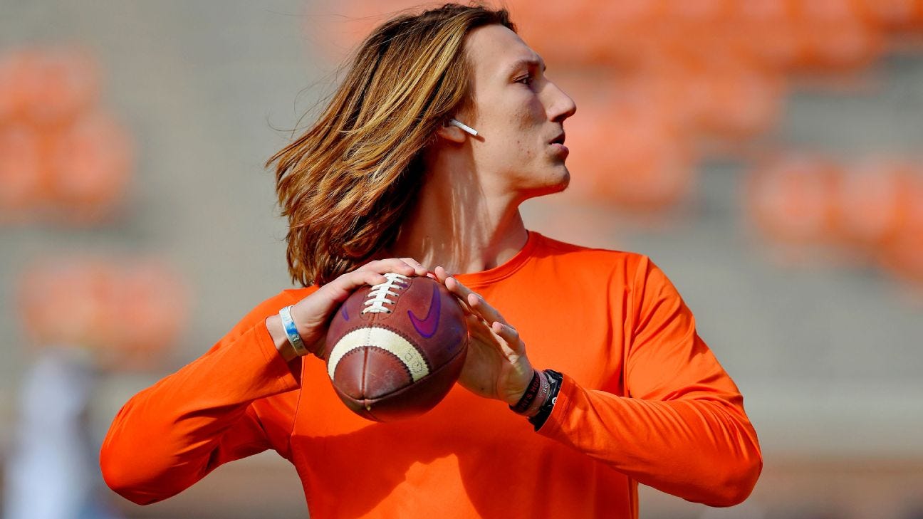 Trevor Lawrence, his hair blown back as he gets ready to throw a pass.