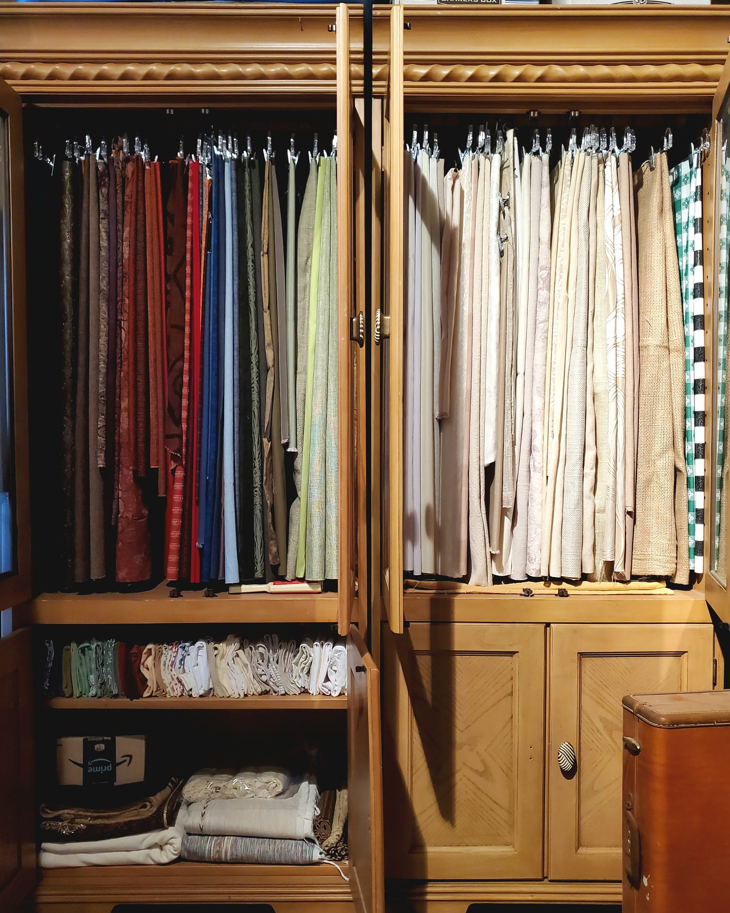 A cabinet full of hanging fabric