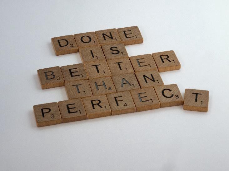 Scrabble letters spelling out: “Done is better than perfect”.