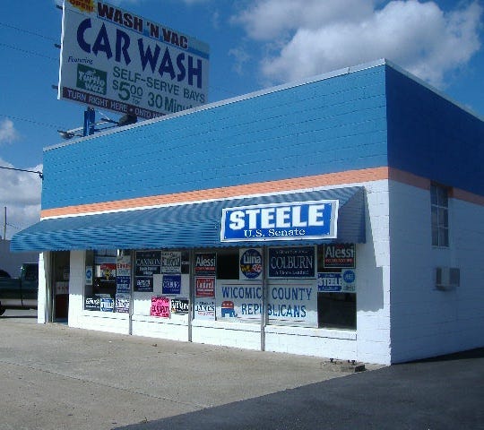 Front view of headquarters showing the signs in the window.