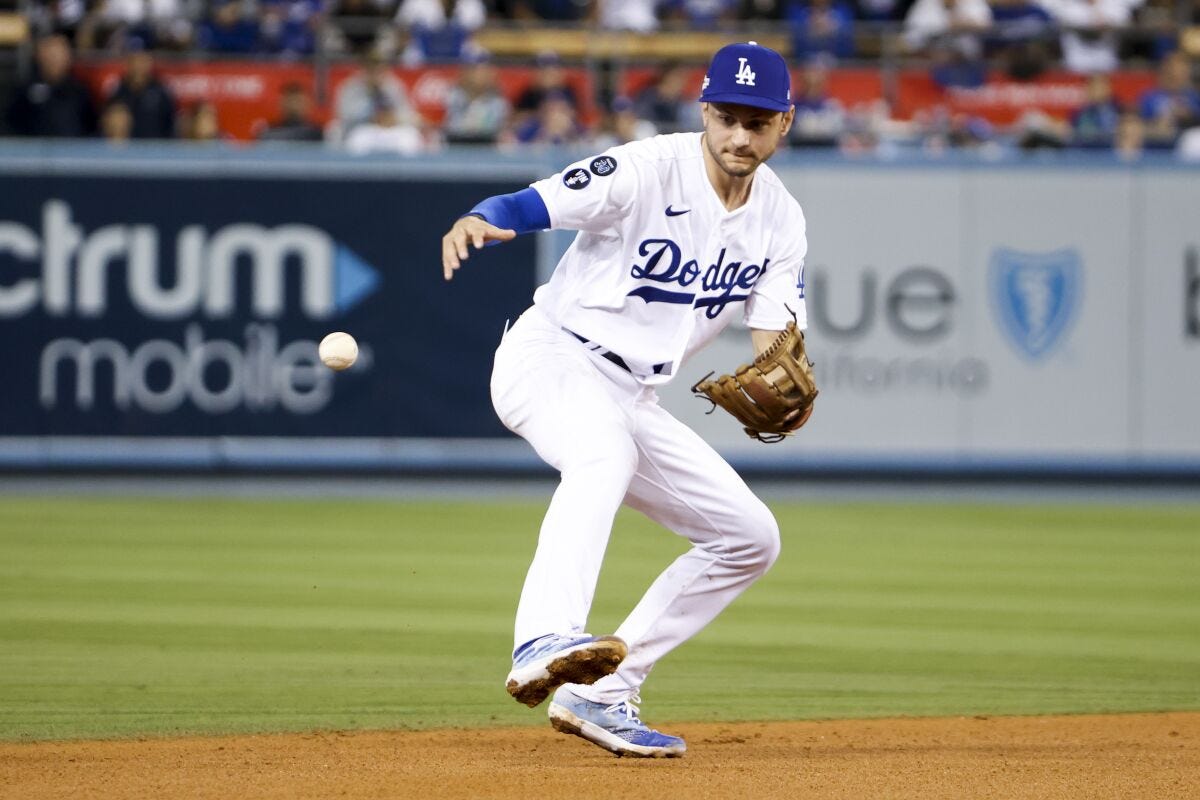 Dodgers shortstop Trea Turner makes a fielding error on a ball hit by San Diego's Wil Myers.