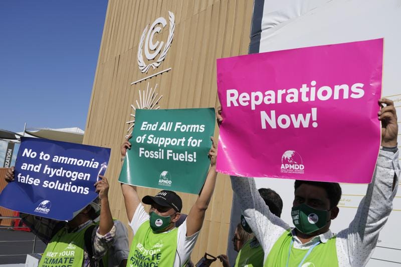 A group of demonstrators participate in an event protesting the use of fossil fuels and calling for reparations at the COP27 U.N. Climate Summit, Wednesday, Nov. 9, 2022, in Sharm el-Sheikh, Egypt. (AP Photo/Peter Dejong)