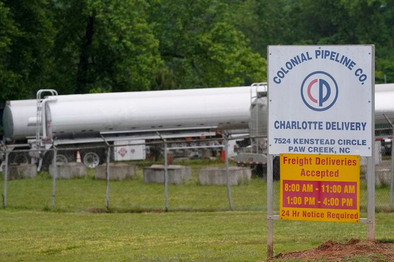 Tanker trucks are parked near the entrance of Colonial Pipeline Company Wednesday, May 12, in Charlotte, N.C. The operator of the nation’s largest fuel pipeline has confirmed it paid $4.4 million to a gang of hackers who broke into its computer systems.