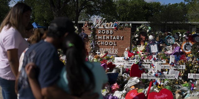 People visit a memorial at Robb Elementary School in Uvalde, Texas, on Thursday, June 2, to pay their respects to the victims killed the school shooting.