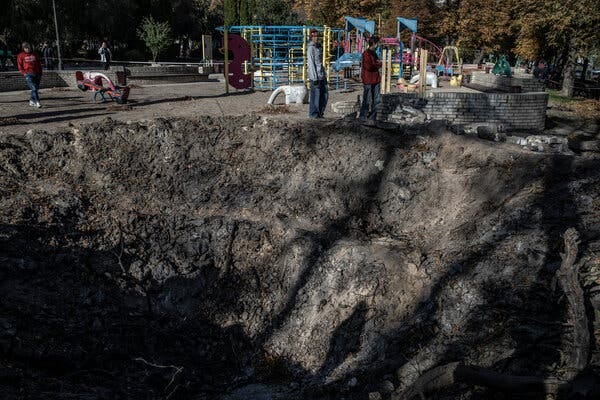 A wave of attacks by Russia in Ukraine’s capital, Kyiv, left a large crater in a playground.