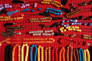 Necklaces of plastic beads on red cloth.jpg