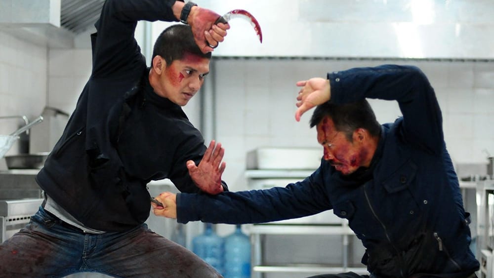 Two men fight in a scene from The Raid 2