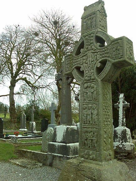 example of a 10th century Irish high cross: Muiredach’s Cross at Monasterboice in County Louth. It's a freestanding stone cross with a ringed cross head and its shaft divided into three panels, each with a tightly-packed tableau of figures.