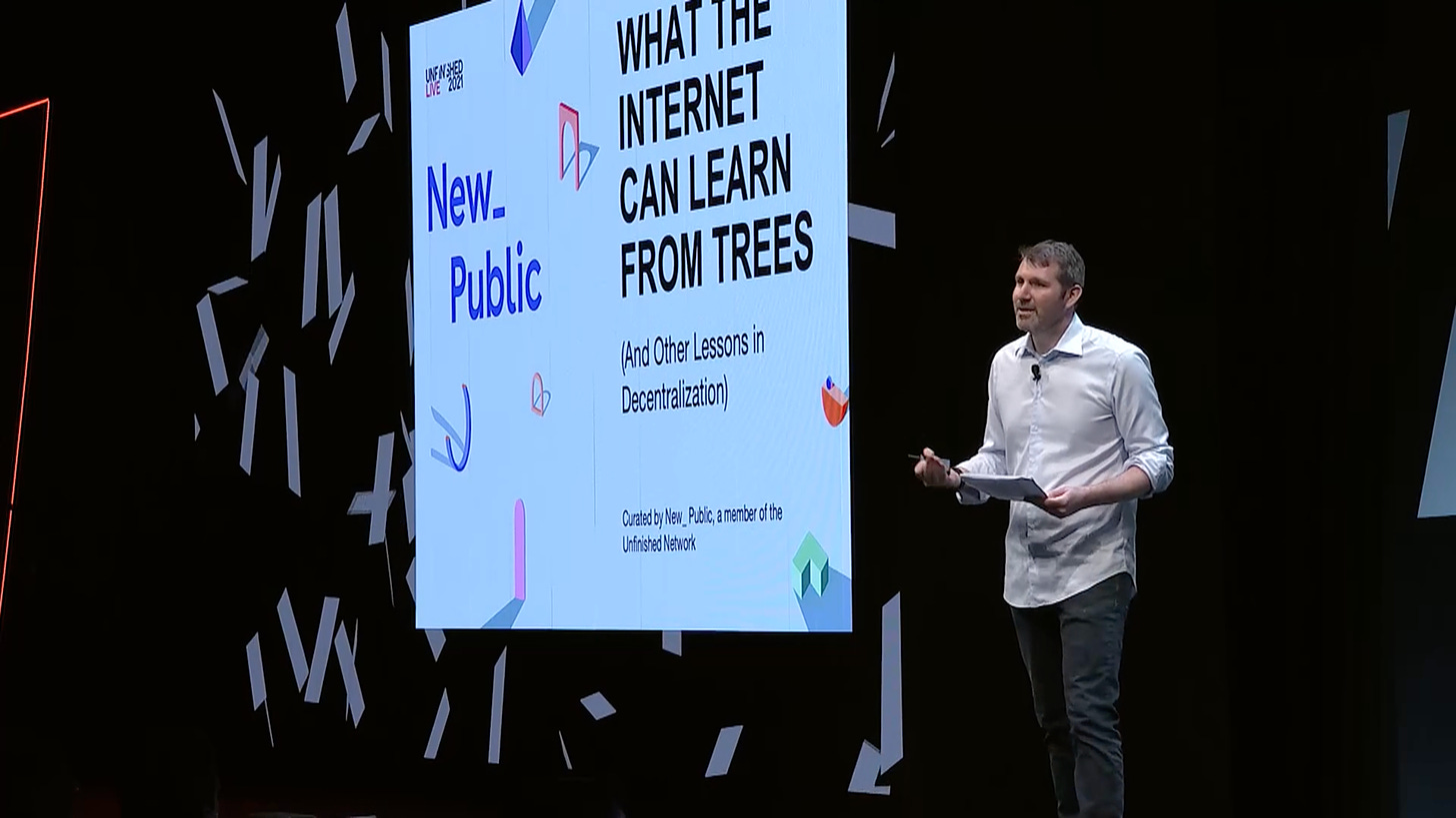 A screenshot of the livestream of our panel, showing Co-director Eli Pariser onstage with a projected screen reading "WHAT THE INTERNET CAN LEARN FROM TREES"