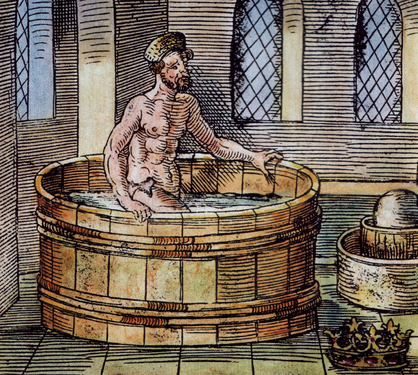 man in a bath with a crown nearby
