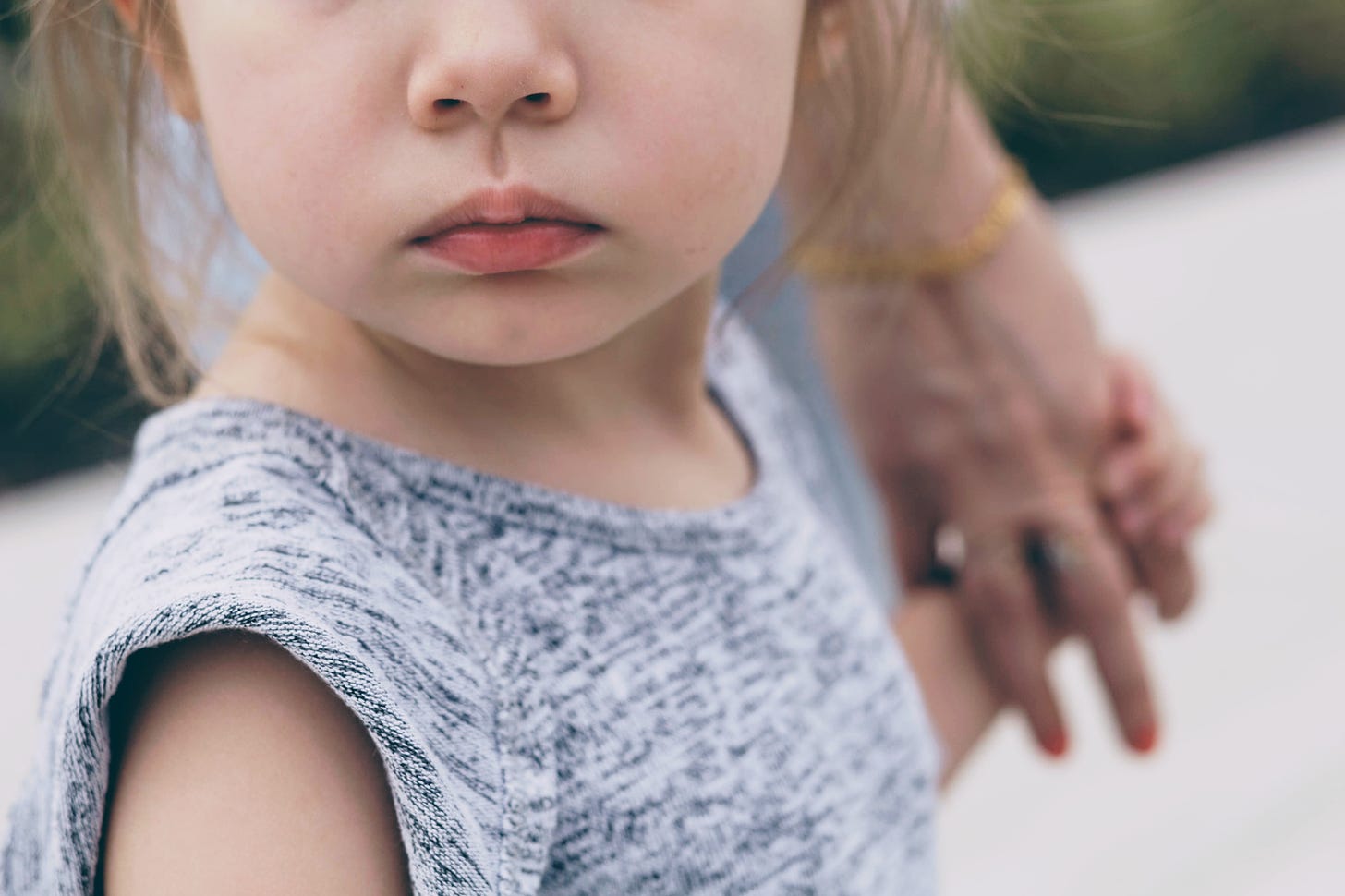Photo of the lower half a toddler's face with a pouting expression. Photo by Joshua Hoehne on Unsplash