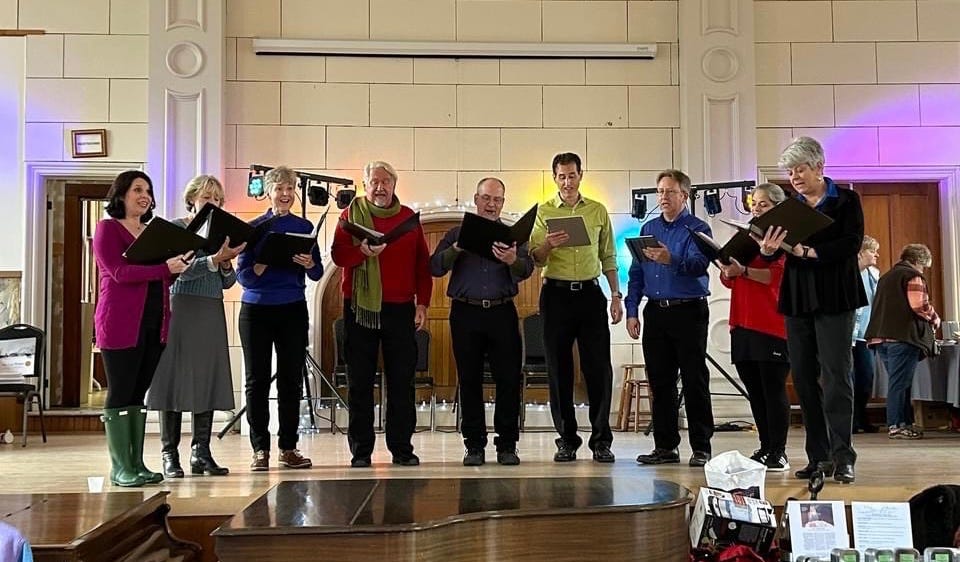 Row of singers in colorful shirts