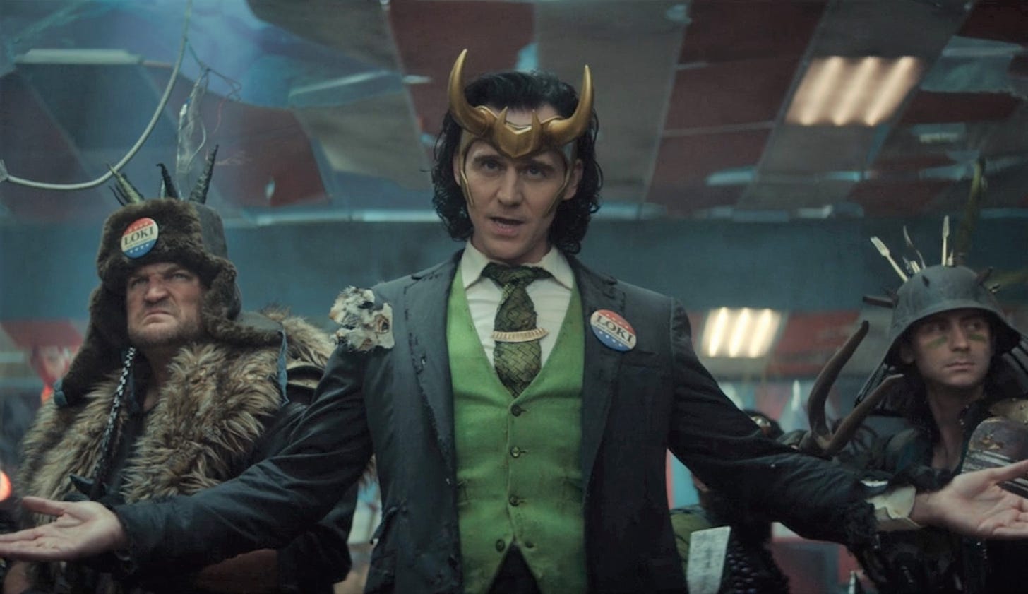President Loki stands with arms open.