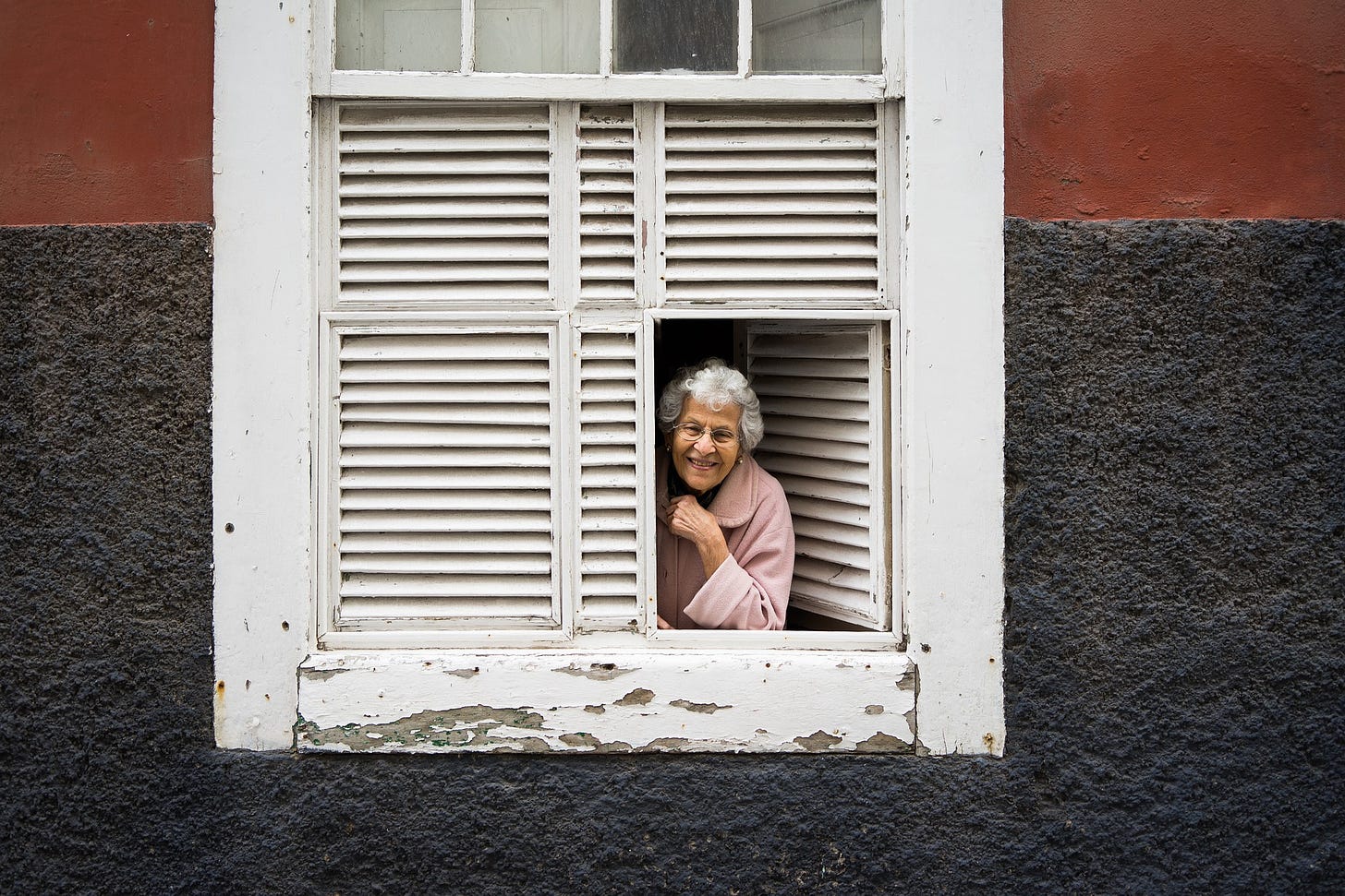 Old woman looking out a window