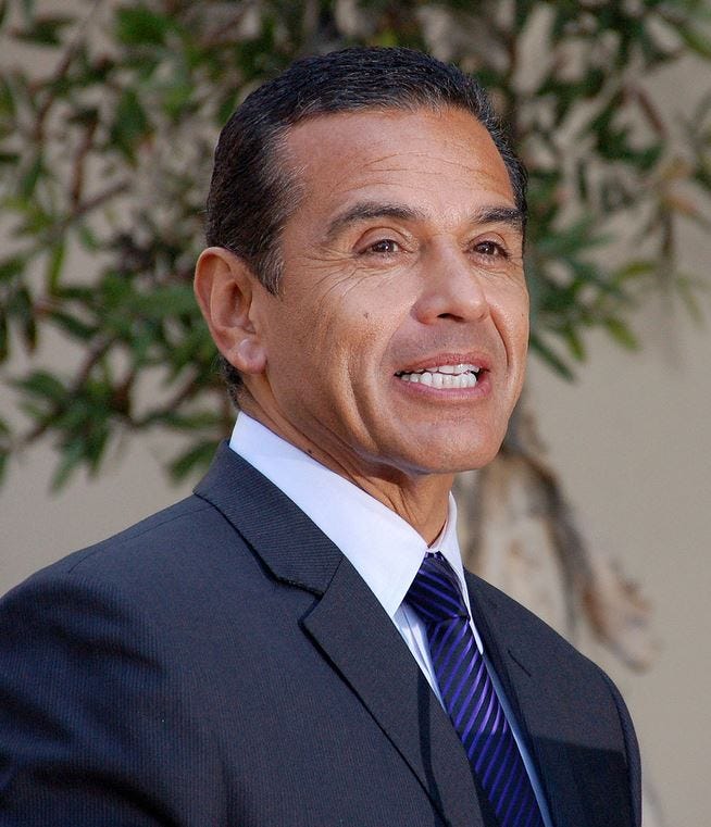 Mayor Antonio Villaraigosa in a dark blue suit with blue striped tie