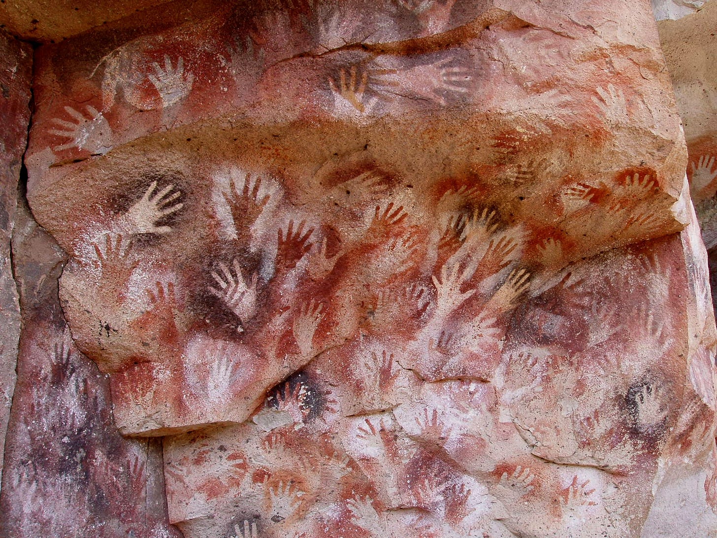 A cave painting: Cueva de las Manos, Perito Moreno, Argentina. The art in the cave is dated between 13,000–9,000 BP, stenciled, mostly left hands are shown.