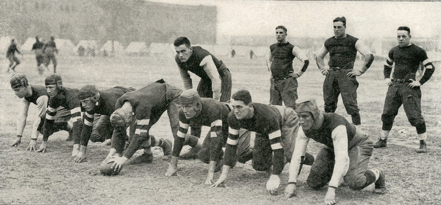 Key members of the 1917 Great Lakes Naval Training Station team were Dominichelli, right end.; Blacklock, right tackle.; Andrus, right guard; Pottinger, center; Robbins, left guard; Hildner, left tackle; Loucks, left end; Conzelman, quarterback; Kirchenberg, right halfback; Smith, fullback; and Truby, let halfback. (Great Lakes Recruit, July 1918)