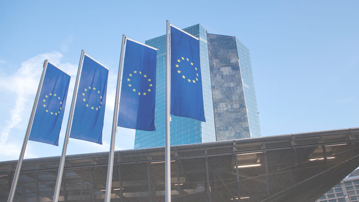 four flags of European Union with a building in the background