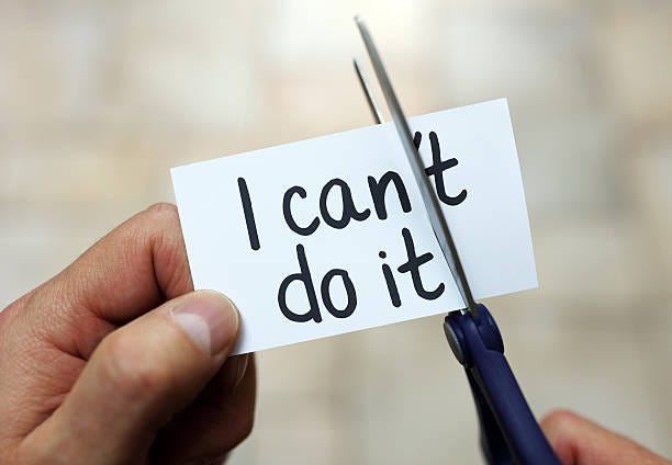 I can do it Man using scissors to remove the word can't to read I can do it concept for self belief, positive attitude and  motivation overcome stock pictures, royalty-free photos & images
