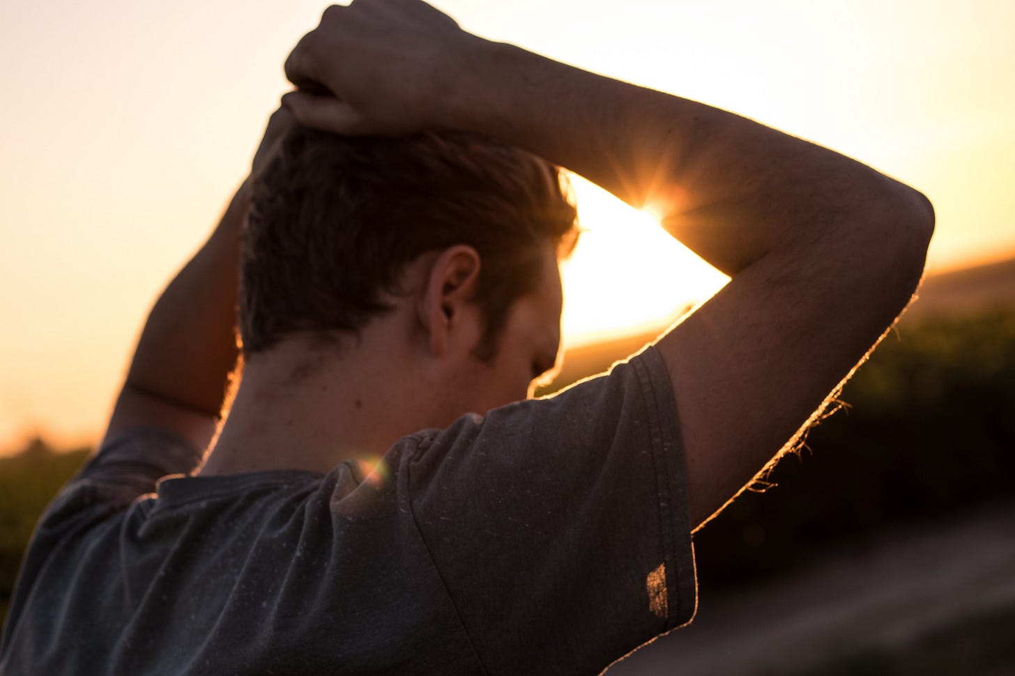 Man with his hands on his head, thinking. For article by Larry G. Maguire