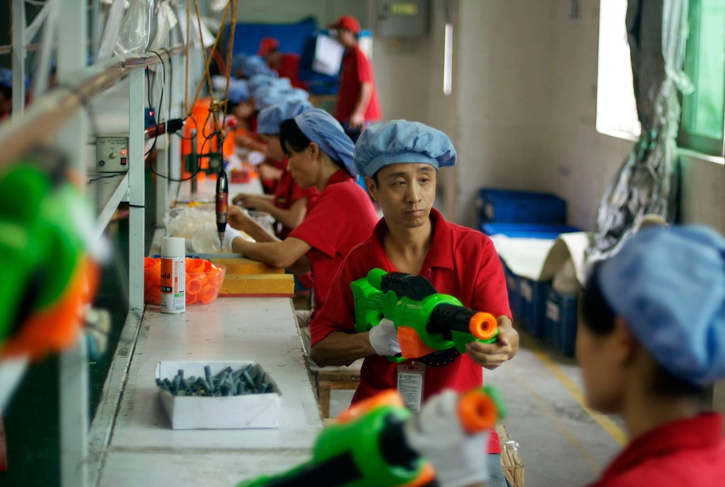 A Zuru employee with a plastic gun in the factory