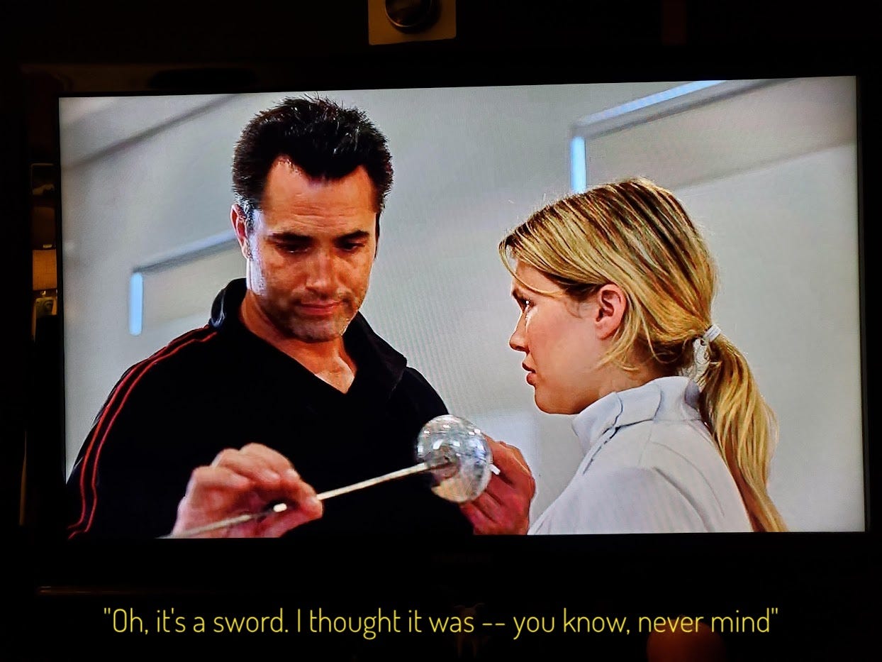 Cole looking down at a fencing sword in a weirdly disappointed way, captioned "Oh it's a sword. I thought -- never mind"