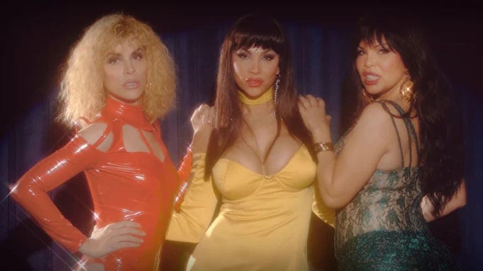 Promotional image for the show Veneno with three women posing in solid color dresses.