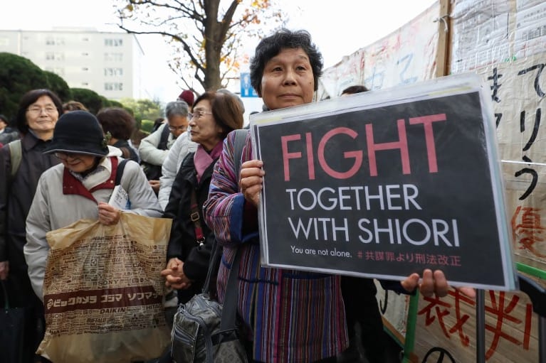 Supporters of Shiori Ito hold up signs at the Tokyo District Court on Wednesday. Ito’s case highlighted the societal obstacles facing Japanese women who allege sexual assault or misconduct. (Takashi Aoyama/AFP/Getty Images)