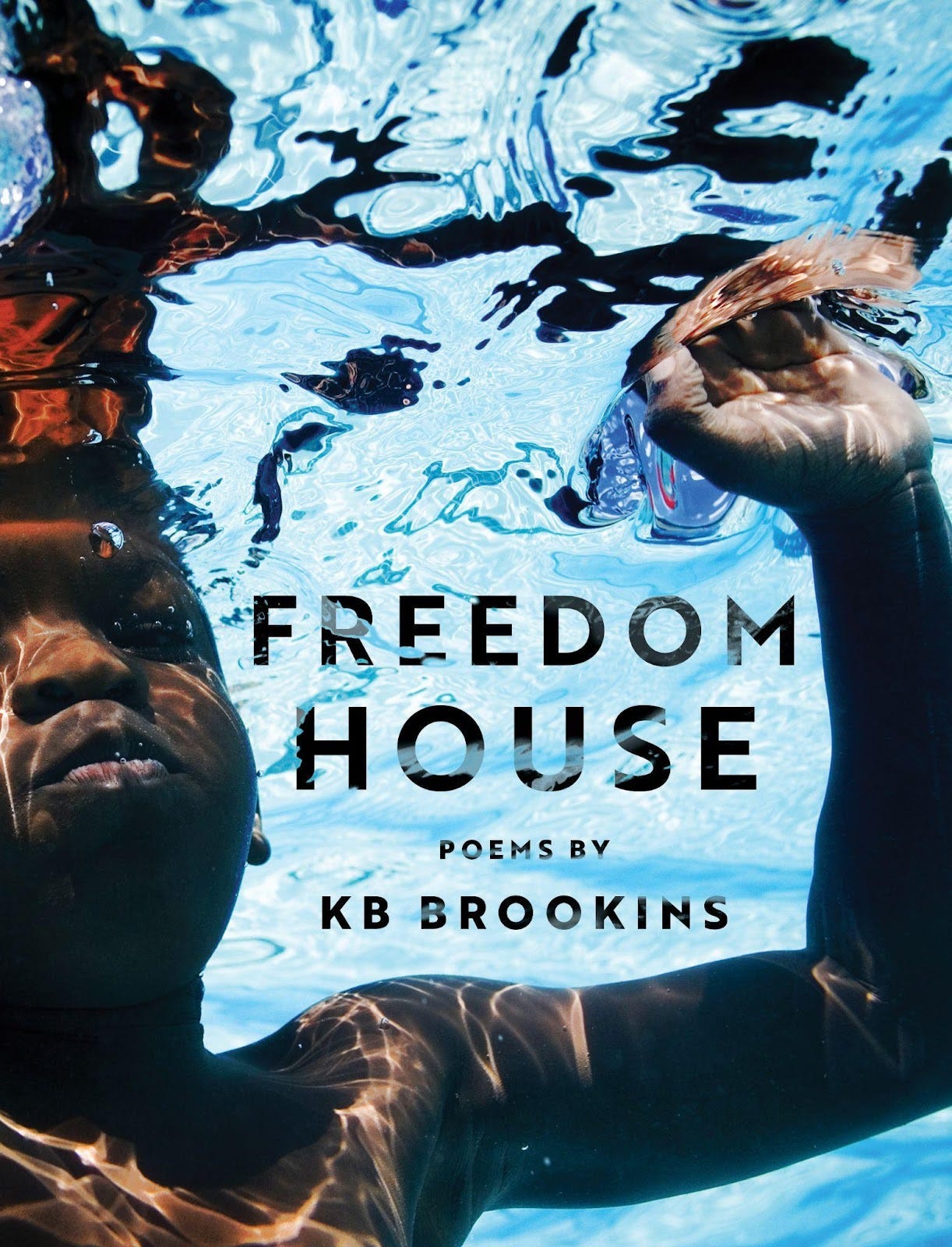 image of a black boy with brown skin holding his breath with his eyes closed underwater, one hand outstretched. The words "Freedom House, poems by KB Brookins" are floating between the boy's face and arm. 