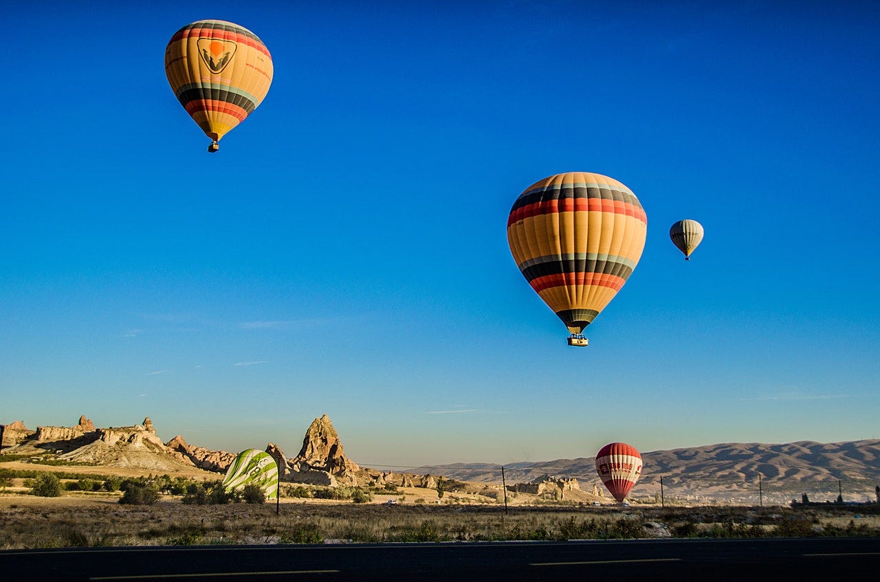 Beautiful photo of hot air balloons over the desert.
