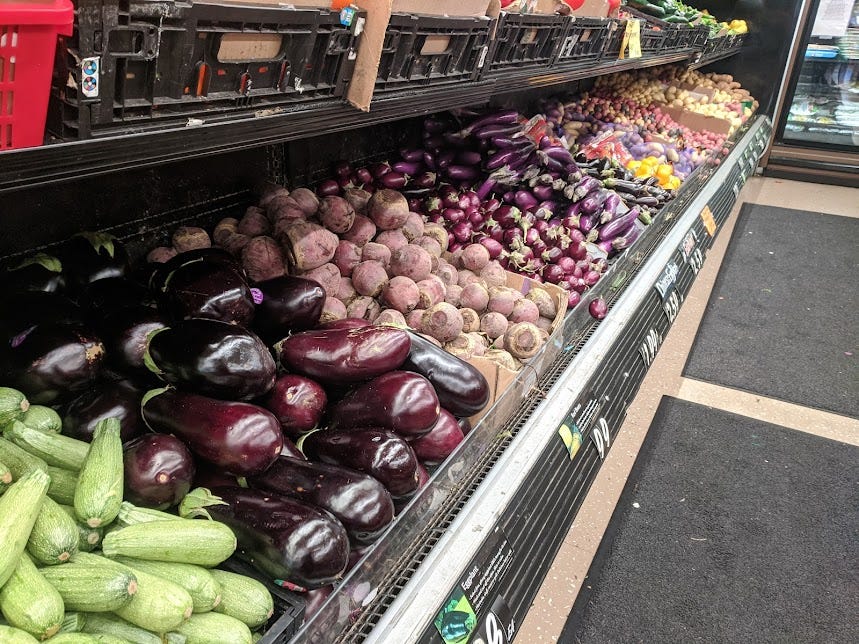 a row of eggplant and root vegetables at Dean's Produce