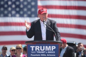 Image of President Trump at a rally - he may have been violating the Emoluments Clause since day one.