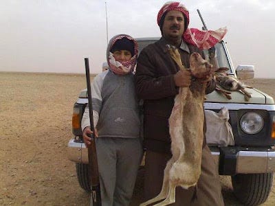 A man and boy with an animal they killed