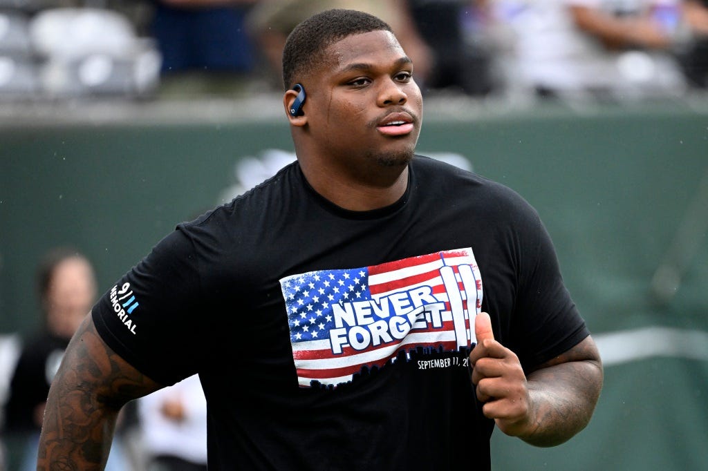 Jets defensive tackle Quinnen Williams warms up wearing a "Never Forget" T-shirt before a game against the Ravens at MetLife Stadium on the anniversary of 9/11.