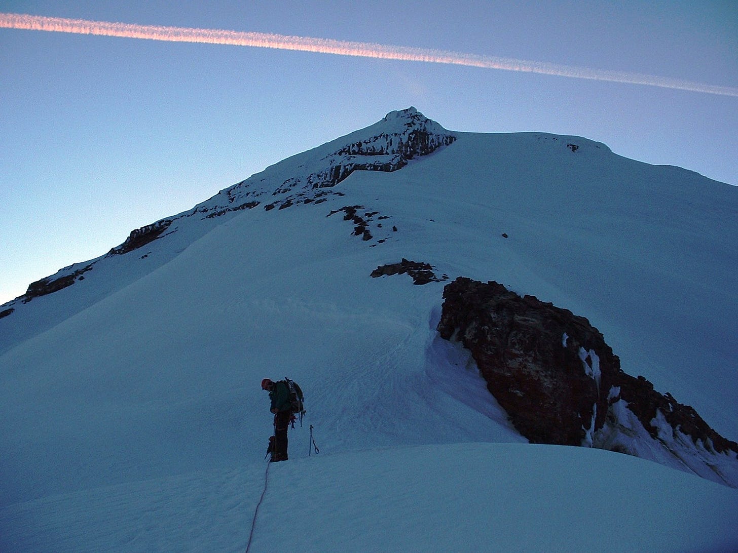 Man pausing on a climb up Mt. Baker