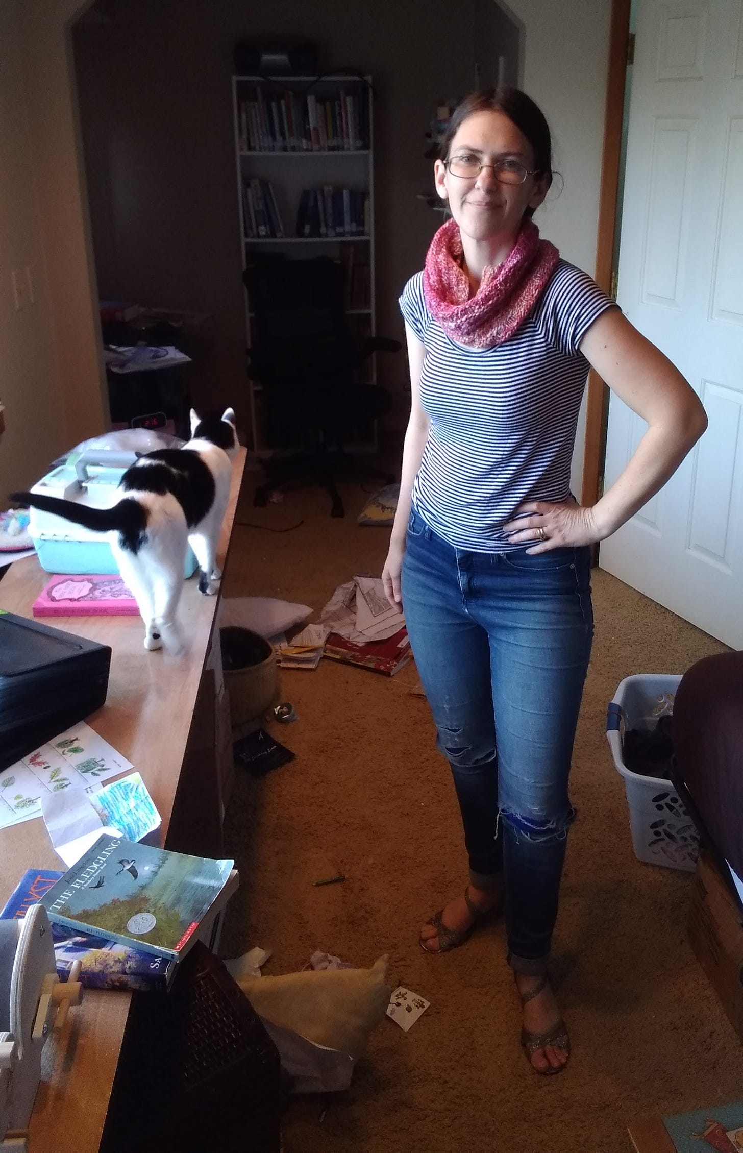 Me with a black and white striped shirt, jeans, strappy silver sandals, and my pink knit cowl. And a cat.